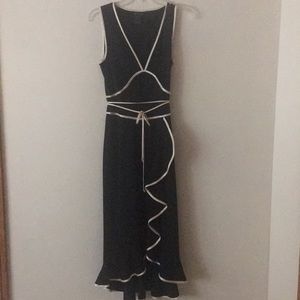 Small black dress with off white satin edging.